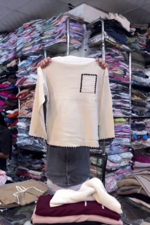 🧵 "Minimalist Modern Café Cream Knit Top with Artistic Black Scalloped Accents and Pocket Detail for Everyday Sophistication Seekers" 🧵​